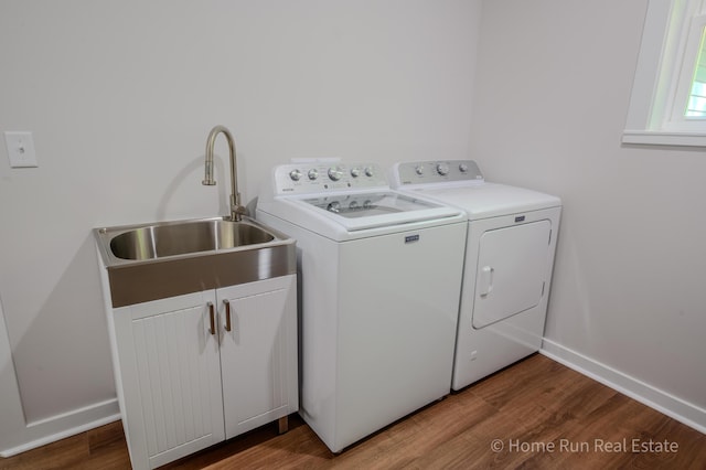 8828 Division Ave S, Byron Center, MI 49315 - washroom with washing machine and dryer, wood finished floors, baseboards, and cabinet space