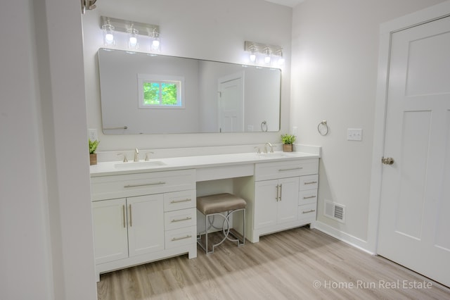 8828 Division Ave S, Byron Center, MI 49315 - full bathroom featuring wood finished floors, double vanity, and baseboards