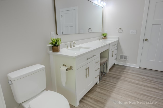 8828 Division Ave S, Byron Center, MI 49315 - bathroom with toilet, wood finished floors, and double vanity
