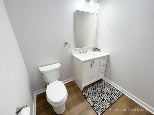 8828 Division Ave S, Byron Center, MI 49315 - bathroom with wood finished floors, toilet, vanity, and baseboards