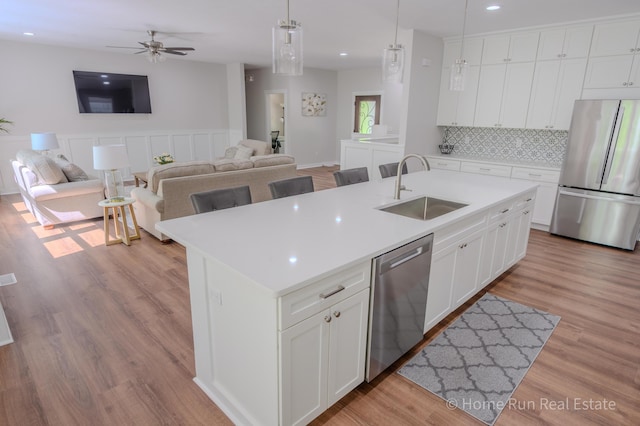 8828 Division Ave S, Byron Center, MI 49315 - kitchen featuring stainless steel appliances, a sink, open floor plan, an island with sink, and recessed lighting