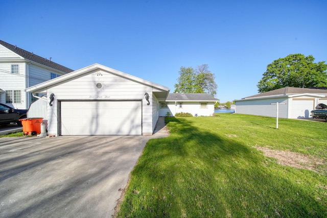 555 S Lakeside Dr, Michigan Center, MI 49254 - view of front of house featuring an attached garage, a front lawn, and driveway