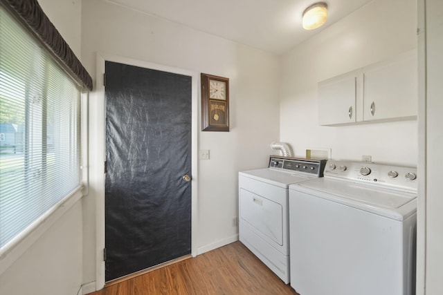 555 S Lakeside Dr, Michigan Center, MI 49254 - clothes washing area with independent washer and dryer, light wood-style floors, cabinet space, and baseboards