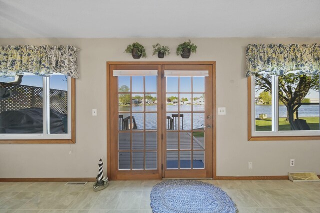 555 S Lakeside Dr, Michigan Center, MI 49254 - doorway to outside featuring a water view and baseboards