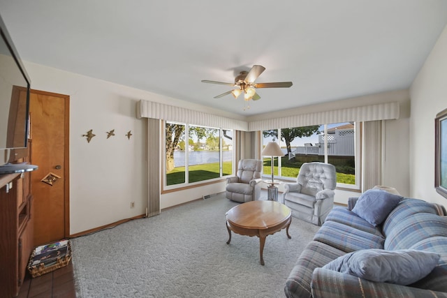 555 S Lakeside Dr, Michigan Center, MI 49254 - living room featuring a ceiling fan, a water view, and baseboards