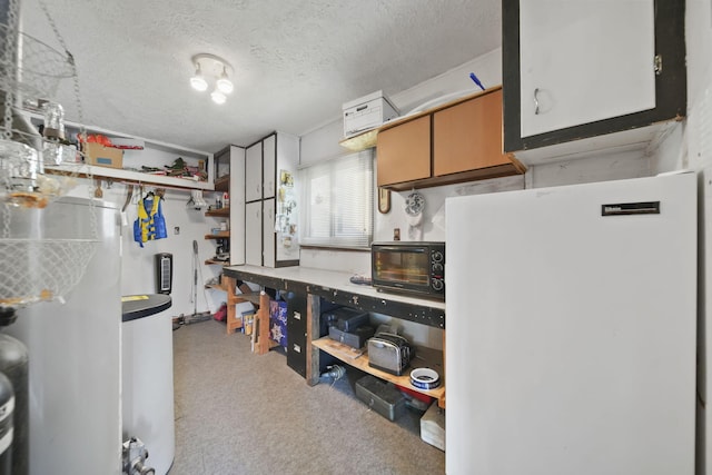 555 S Lakeside Dr, Michigan Center, MI 49254 - kitchen featuring freestanding refrigerator, carpet, and a textured ceiling