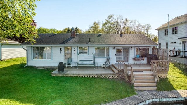 555 S Lakeside Dr, Michigan Center, MI 49254 - rear view of property featuring a lawn, a chimney, and a wooden deck