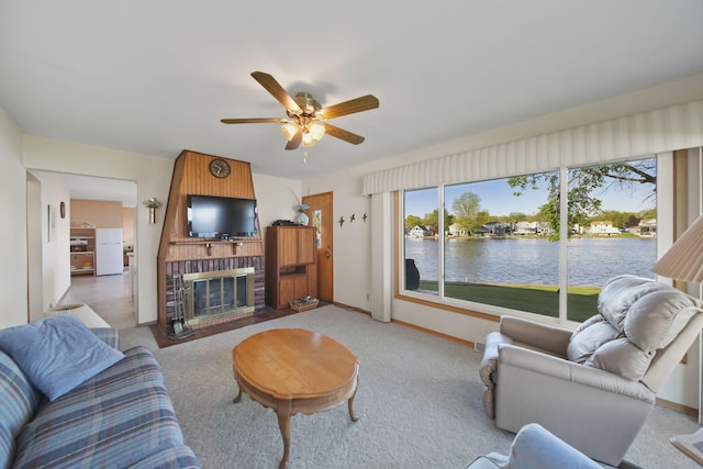 555 S Lakeside Dr, Michigan Center, MI 49254 - living room featuring ceiling fan, baseboards, carpet floors, and a brick fireplace