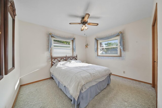 555 S Lakeside Dr, Michigan Center, MI 49254 - carpeted bedroom with baseboards and a ceiling fan