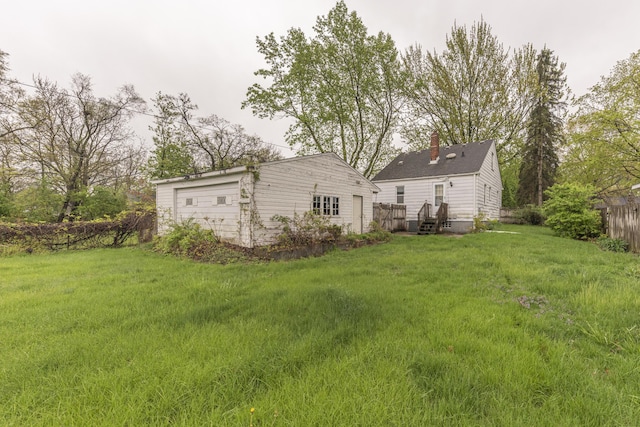 885 Hawthorne Ave, Ypsilanti, MI 48198 - rear view of property with an outbuilding, a yard, and a chimney