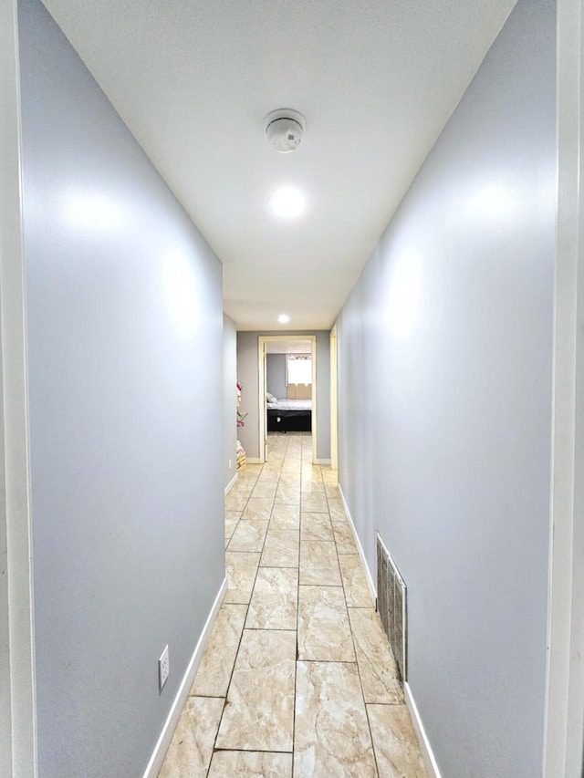 hall featuring baseboards