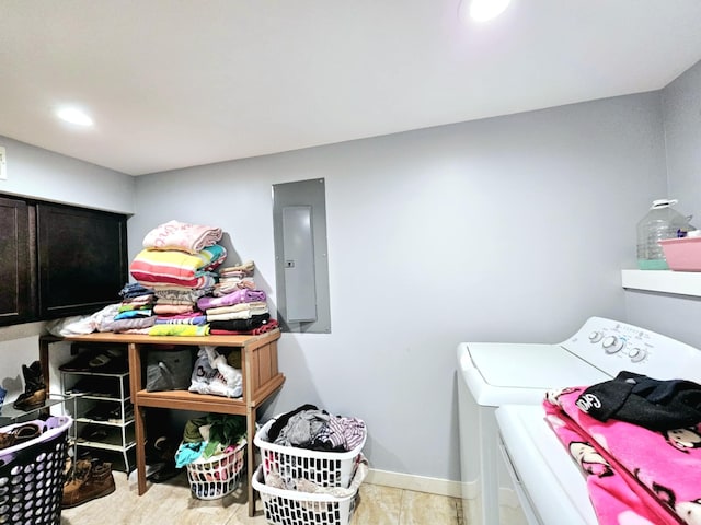 laundry room featuring electric panel, independent washer and dryer, cabinet space, and baseboards