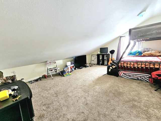 bedroom featuring vaulted ceiling, carpet floors, and a textured ceiling