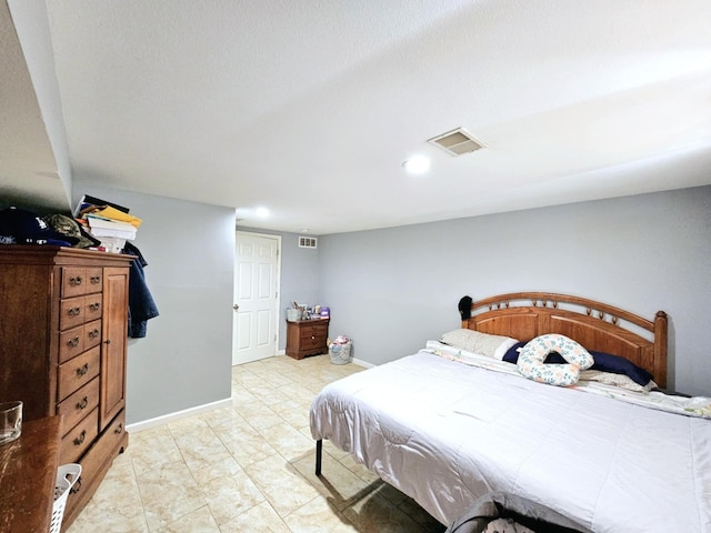 bedroom featuring baseboards and recessed lighting