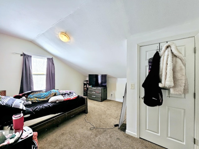 bedroom featuring lofted ceiling and light colored carpet