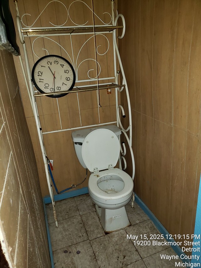 19200 Blackmoor St, Detroit, MI 48234 - bathroom featuring toilet, tile patterned floors, and wood walls