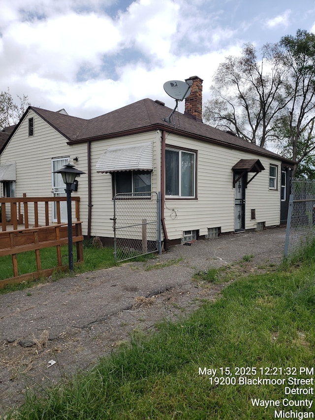 19200 Blackmoor St, Detroit, MI 48234 - back of house featuring a chimney and roof with shingles