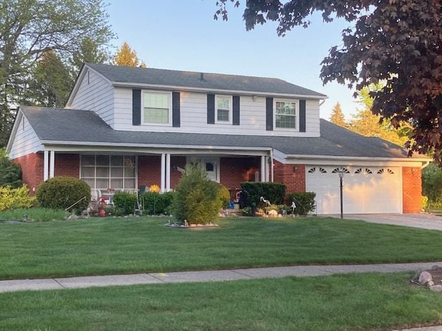 5244 Folkstone Dr, Troy, MI 48085 - traditional-style house featuring concrete driveway, brick siding, and a front yard