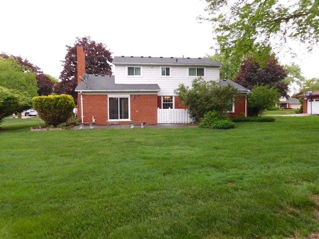 5244 Folkstone Dr, Troy, MI 48085 - rear view of house featuring brick siding, a chimney, and a lawn