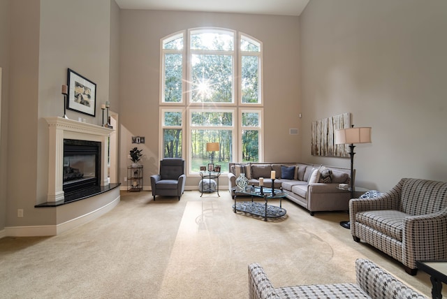 8307 Granite Ct, Dexter, MI 48130 - living room featuring a high ceiling, baseboards, carpet, and a high end fireplace