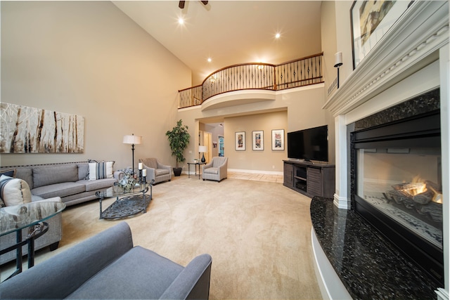 8307 Granite Ct, Dexter, MI 48130 - living room featuring high vaulted ceiling, a premium fireplace, light colored carpet, recessed lighting, and baseboards