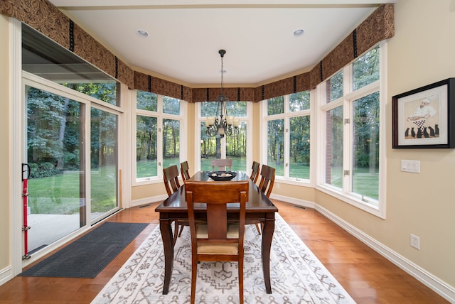 8307 Granite Ct, Dexter, MI 48130 - sunroom / solarium featuring a chandelier, wood finished floors, baseboards, and recessed lighting