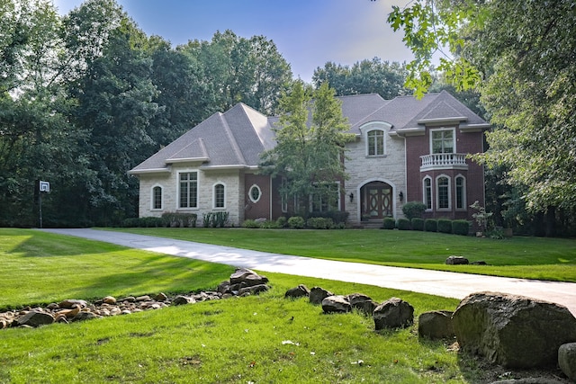 8307 Granite Ct, Dexter, MI 48130 - french provincial home featuring stone siding and a front yard