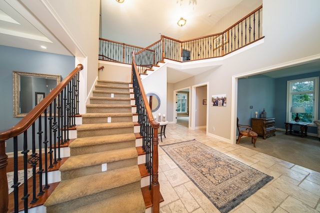 8307 Granite Ct, Dexter, MI 48130 - staircase featuring stone tile flooring, a high ceiling, baseboards, and recessed lighting