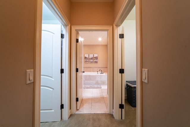 8307 Granite Ct, Dexter, MI 48130 - hallway with light colored carpet and light tile patterned flooring