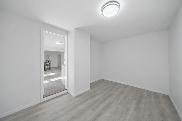 unfurnished bedroom featuring light wood-style floors and baseboards