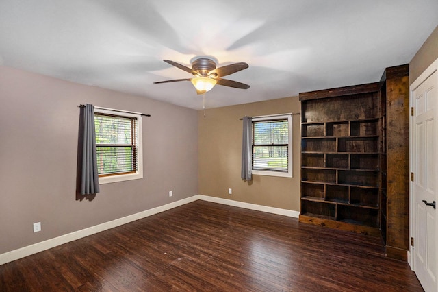 1977 E 40th St, White Cloud, MI 49349 - empty room with healthy amount of natural light, wood finished floors, a ceiling fan, and baseboards