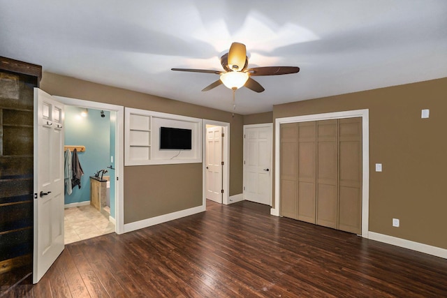 1977 E 40th St, White Cloud, MI 49349 - unfurnished bedroom featuring hardwood / wood-style flooring, baseboards, a ceiling fan, and ensuite bathroom