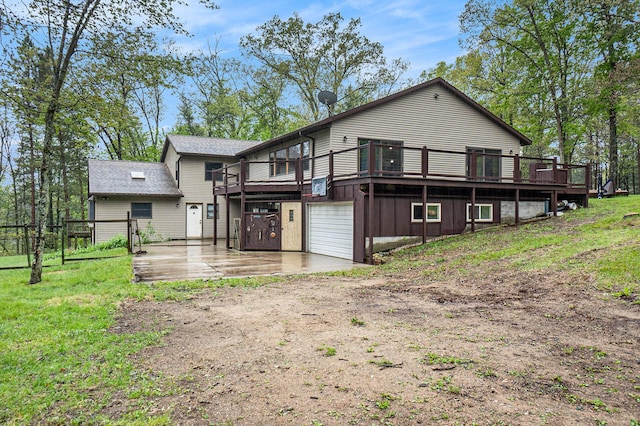 1977 E 40th St, White Cloud, MI 49349 - rear view of property featuring driveway, a wooden deck, and an attached garage