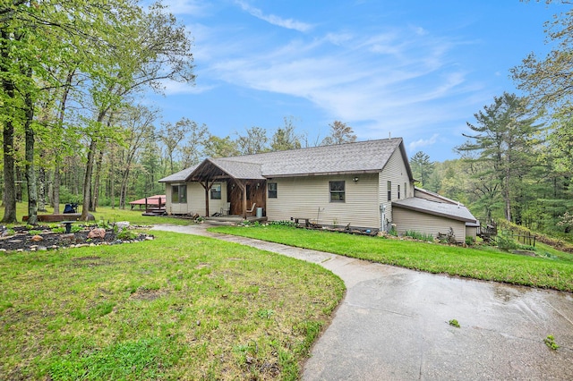 1977 E 40th St, White Cloud, MI 49349 - view of front of house with a front yard and roof with shingles