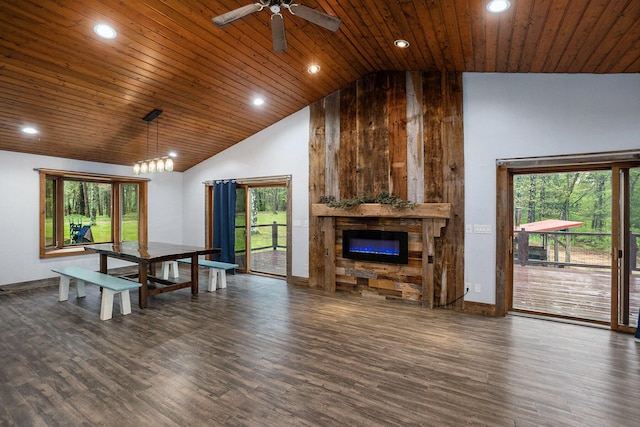 1977 E 40th St, White Cloud, MI 49349 - living area with high vaulted ceiling, dark wood-style flooring, wood ceiling, a stone fireplace, and healthy amount of natural light