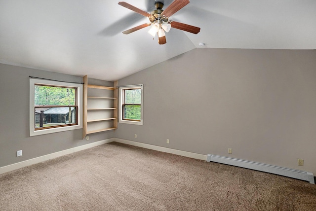 1977 E 40th St, White Cloud, MI 49349 - unfurnished room with a baseboard heating unit, healthy amount of natural light, vaulted ceiling, baseboards, and a ceiling fan