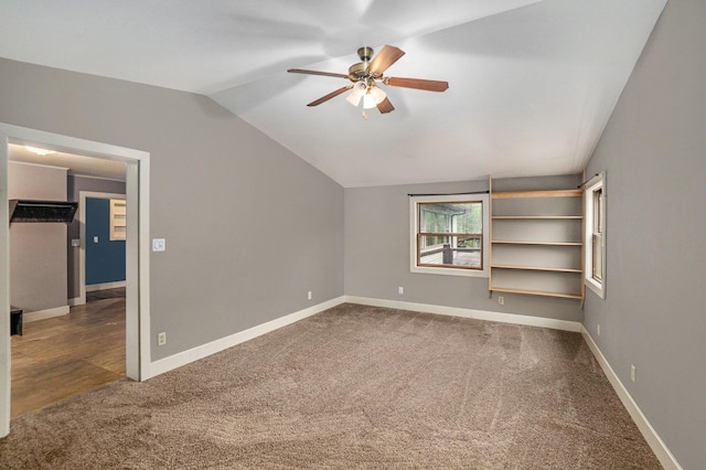1977 E 40th St, White Cloud, MI 49349 - unfurnished bedroom featuring lofted ceiling, carpet flooring, baseboards, and ceiling fan
