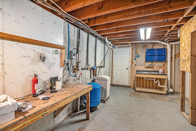1977 E 40th St, White Cloud, MI 49349 - unfinished basement with a workshop area and a water pressure tank