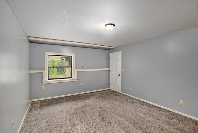 1977 E 40th St, White Cloud, MI 49349 - empty room featuring carpet and baseboards