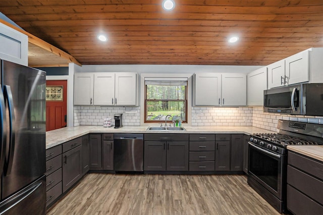 1977 E 40th St, White Cloud, MI 49349 - kitchen featuring stainless steel appliances, a sink, wooden ceiling, backsplash, and recessed lighting