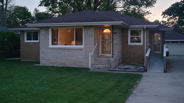 view of front of house with driveway, a front yard, a chimney, and stone siding
