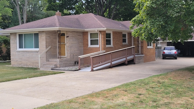 single story home with driveway, stone siding, roof with shingles, a chimney, and a front yard