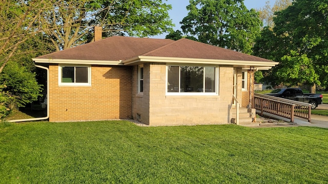 view of front of property with a front yard and roof with shingles