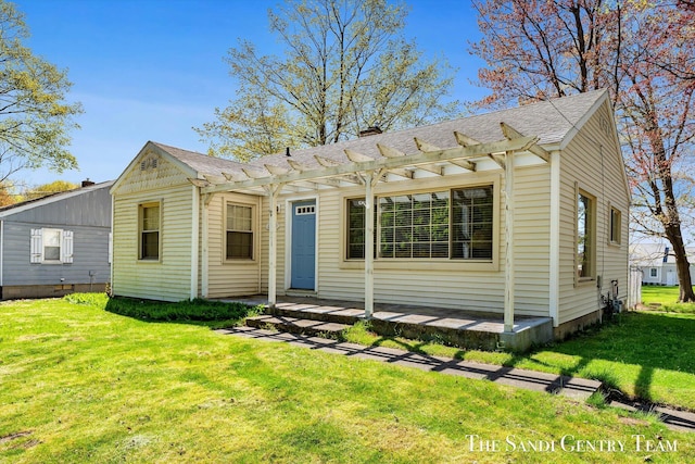 bungalow-style home featuring a front lawn, a pergola, a chimney, and a shingled roof