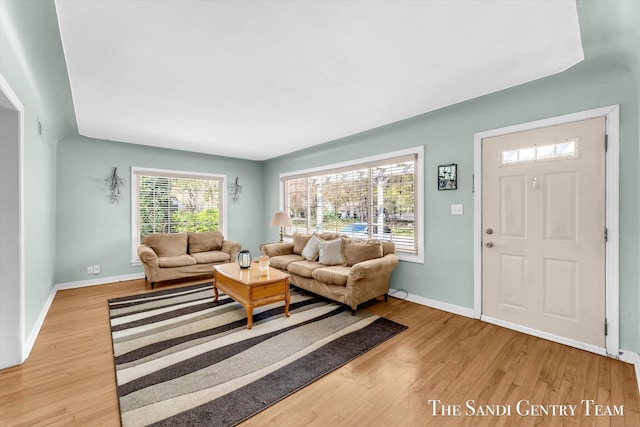 living room featuring wood finished floors and baseboards