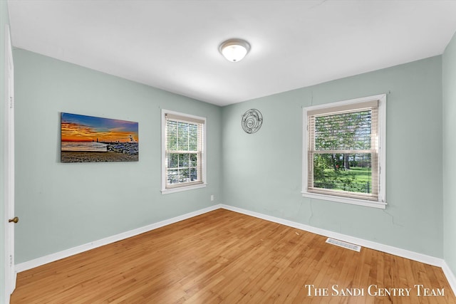 empty room with wood finished floors and baseboards