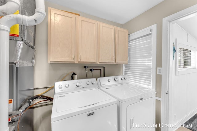 laundry room with cabinet space, washing machine and clothes dryer, and baseboards