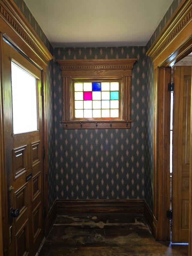 318 W King St, Owosso, MI 48867 - entryway featuring wallpapered walls, baseboards, and dark wood-style floors