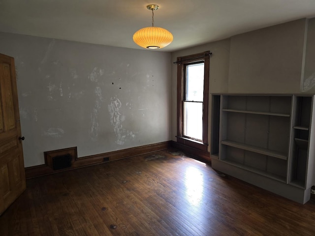 318 W King St, Owosso, MI 48867 - unfurnished living room with wood finished floors and baseboards