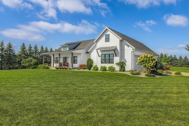 5353 N Graham Rd, Freeland, MI 48623 - modern inspired farmhouse with a porch, a front lawn, a garage, and board and batten siding
